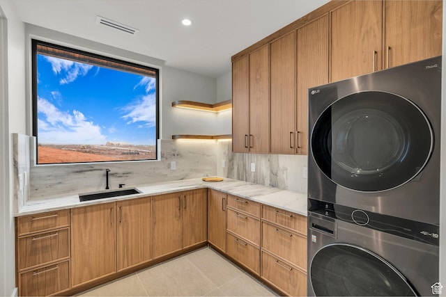 63 E Colima Rd, Washington, UT 84780 - laundry area featuring stacked washing machine and dryer, cabinet space, recessed lighting, and light tile patterned floors