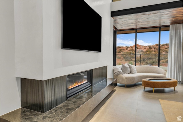 63 E Colima Rd, Washington, UT 84780 - living area featuring a glass covered fireplace and floor to ceiling windows