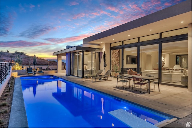 63 E Colima Rd, Washington, UT 84780 - pool at dusk with a patio, an outdoor hangout area, and fence