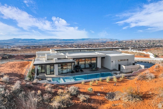 63 E Colima Rd, Washington, UT 84780 - back of house with a mountain view, an outdoor pool, and stucco siding