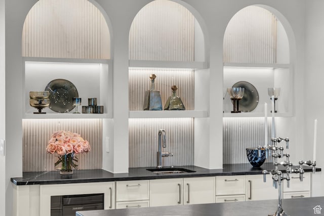 63 E Colima Rd, Washington, UT 84780 - detailed view of bar with sink, dark countertops, white cabinets, and beverage cooler