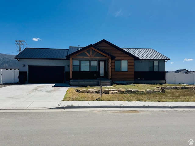 205 W 400 S, Ephraim, UT 84627 - view of front facade featuring a garage, concrete driveway, a gate, and metal roof