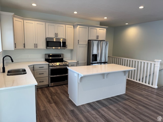 205 W 400 S, Ephraim, UT 84627 - kitchen with appliances with stainless steel finishes, a sink, dark wood-style flooring, recessed lighting, and a center island