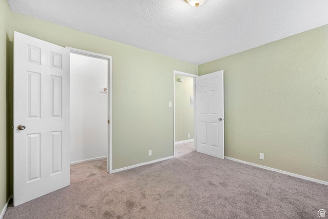 4409 S Rosehaven Ct Unit B, West Valley City, UT 84120 - unfurnished bedroom with carpet floors, a textured ceiling, and baseboards