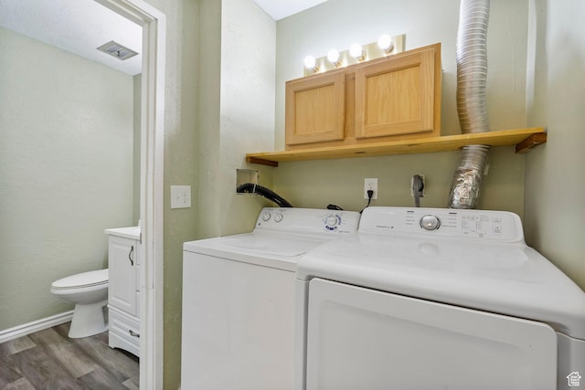 4409 S Rosehaven Ct Unit B, West Valley City, UT 84120 - clothes washing area with wood finished floors, cabinet space, baseboards, visible vents, and independent washer and dryer