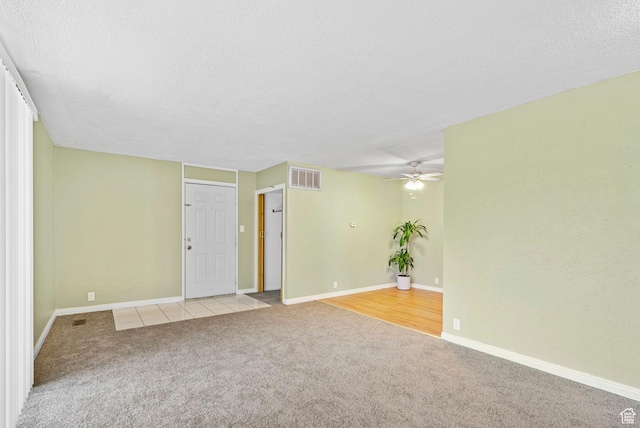 4409 S Rosehaven Ct Unit B, West Valley City, UT 84120 - spare room featuring light colored carpet, a ceiling fan, a textured ceiling, and visible vents