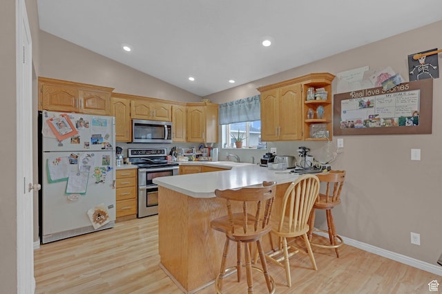 260 S 370 E, Smithfield, UT 84335 - kitchen with lofted ceiling, sink, a kitchen breakfast bar, kitchen peninsula, and stainless steel appliances
