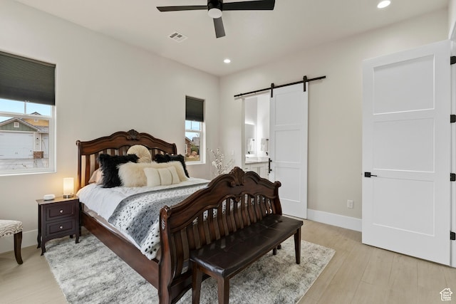 802 E Prairie Way, Washington, UT 84780 - bedroom featuring ceiling fan, a barn door, light hardwood / wood-style floors, and ensuite bath