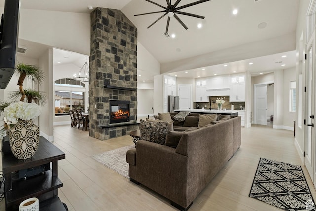 802 E Prairie Way, Washington, UT 84780 - living room featuring a fireplace, high vaulted ceiling, light hardwood / wood-style flooring, and a notable chandelier
