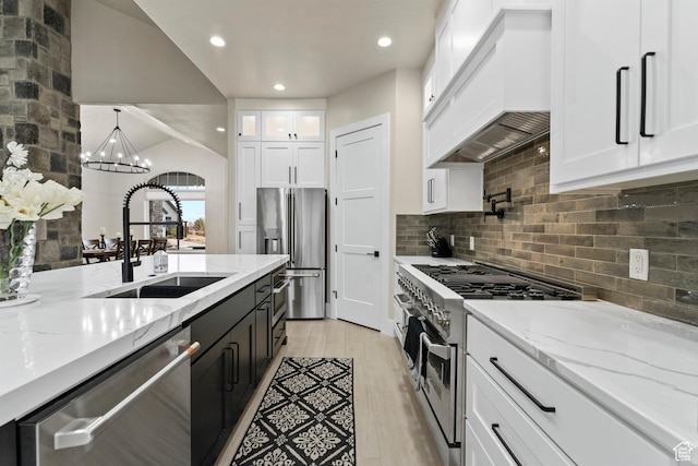 802 E Prairie Way, Washington, UT 84780 - kitchen featuring sink, premium range hood, white cabinetry, high end appliances, and decorative light fixtures
