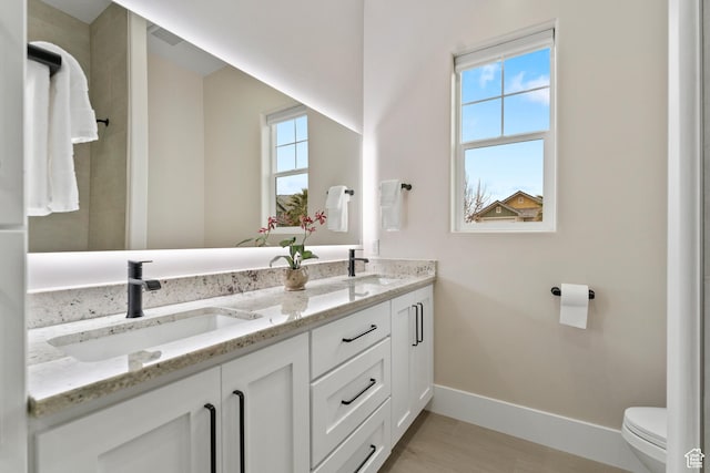 802 E Prairie Way, Washington, UT 84780 - bathroom featuring vanity, toilet, and a wealth of natural light