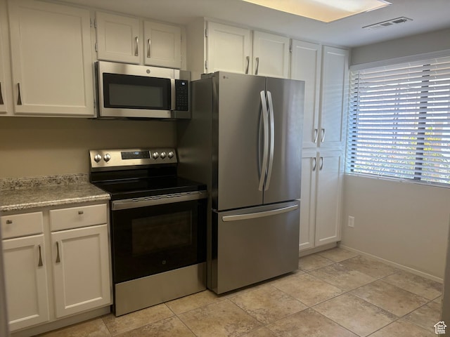 kitchen featuring white cabinetry and appliances with stainless steel finishes