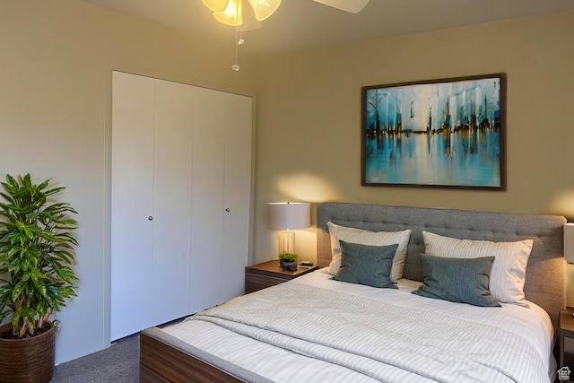 carpeted bedroom with ceiling fan and a closet
