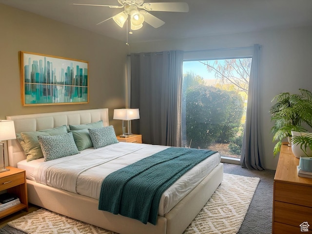 bedroom featuring ceiling fan, carpet floors, and multiple windows