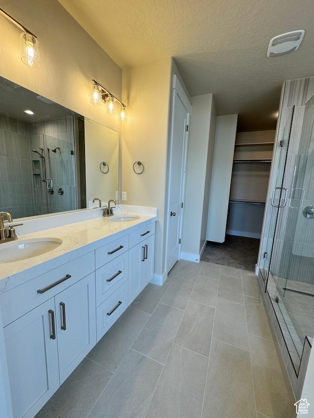 1273 W Hendrix St Unit 145, Riverton, UT 84065 - bathroom with tile patterned flooring, vanity, a textured ceiling, and an enclosed shower
