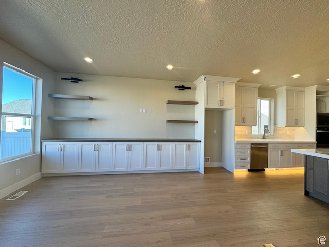 1273 W Hendrix St Unit 145, Riverton, UT 84065 - kitchen featuring tasteful backsplash, sink, white cabinets, light hardwood / wood-style floors, and stainless steel appliances