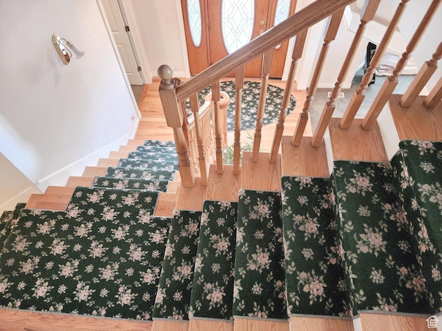 8298 S Arlington Ct, West Jordan, UT 84088 - stairs featuring a healthy amount of sunlight and wood-type flooring