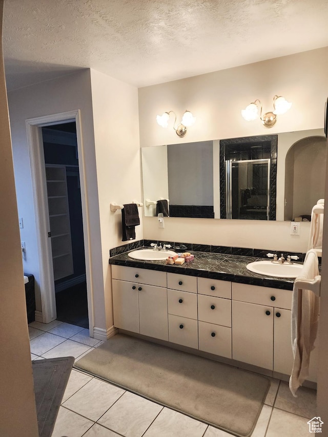 8298 S Arlington Ct, West Jordan, UT 84088 - bathroom with tile patterned flooring, vanity, and a textured ceiling