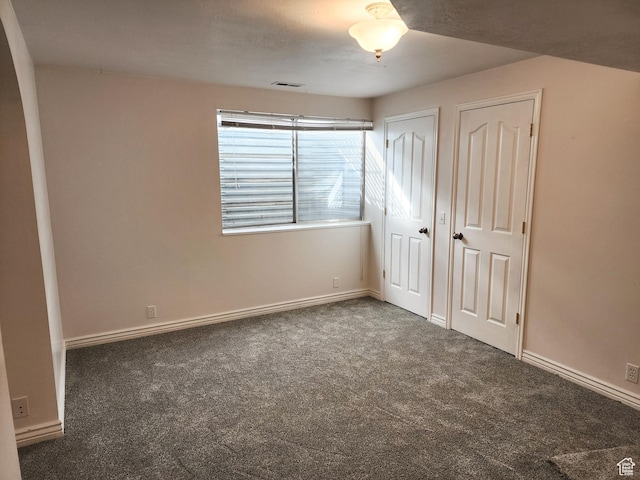 8298 S Arlington Ct, West Jordan, UT 84088 - unfurnished bedroom featuring two closets and dark colored carpet