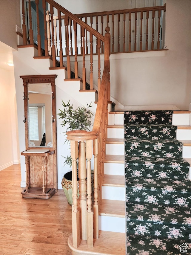 8298 S Arlington Ct, West Jordan, UT 84088 - staircase featuring hardwood / wood-style floors