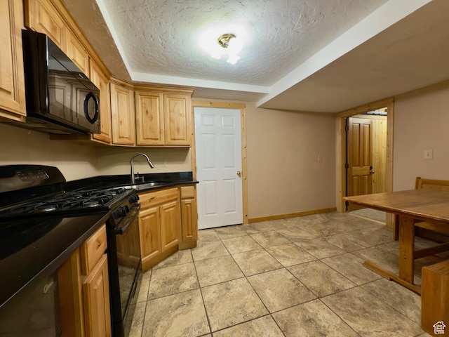 485 S Woodland Hills Dr, Woodland Hills, UT 84653 - kitchen with black appliances, a textured ceiling, dark countertops, a sink, and light tile patterned floors