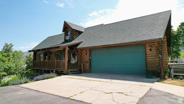 485 S Woodland Hills Dr, Woodland Hills, UT 84653 - log-style house with covered porch, a shingled roof, an attached garage, driveway, and log exterior