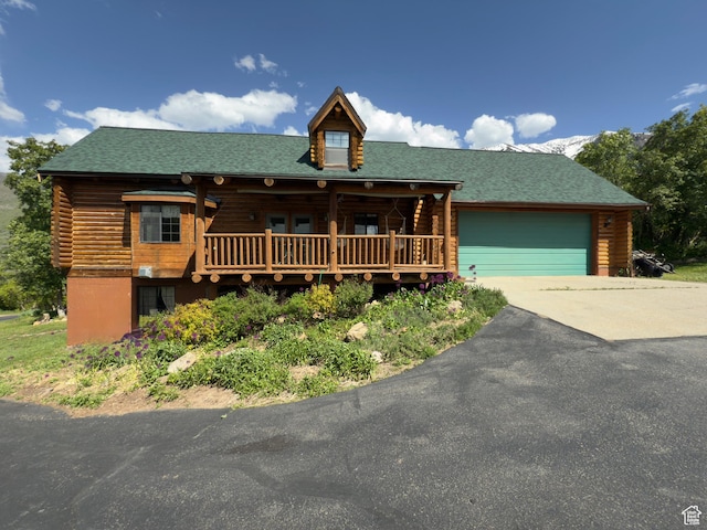 485 S Woodland Hills Dr, Woodland Hills, UT 84653 - log cabin with concrete driveway, log siding, an attached garage, and a porch