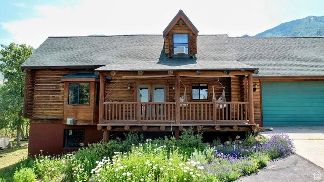 485 S Woodland Hills Dr, Woodland Hills, UT 84653 - log cabin featuring log siding, concrete driveway, a mountain view, and an attached garage
