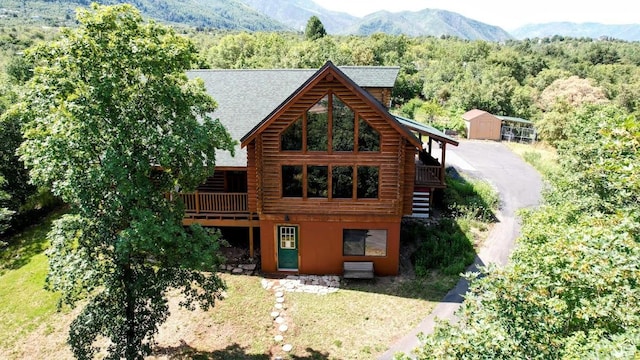 485 S Woodland Hills Dr, Woodland Hills, UT 84653 - rear view of house with log siding, a forest view, and a shingled roof