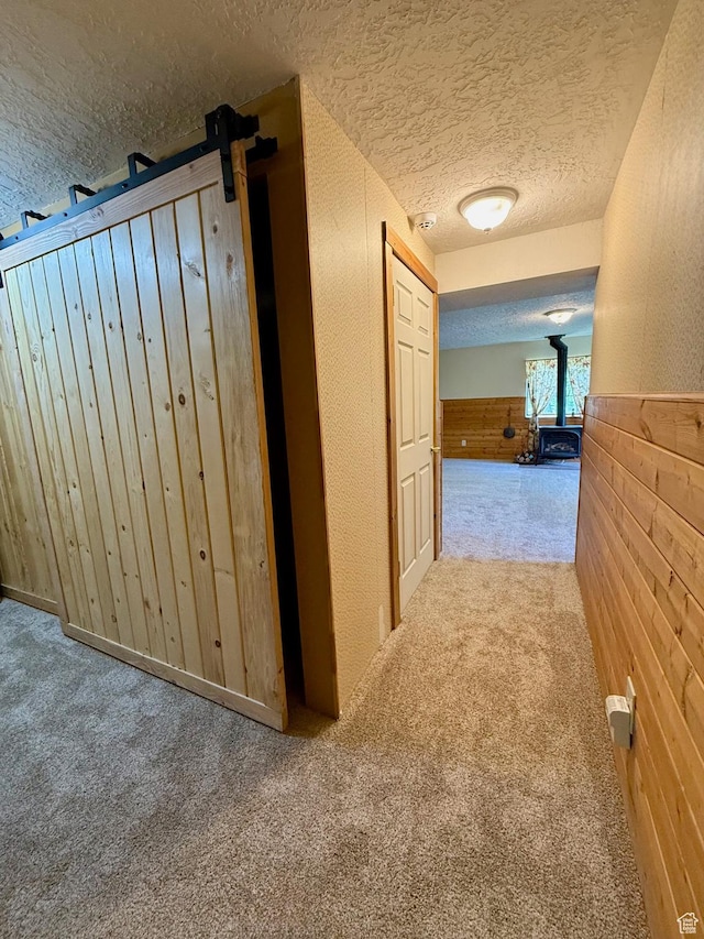 485 S Woodland Hills Dr, Woodland Hills, UT 84653 - hallway featuring a textured ceiling, carpet floors, a wainscoted wall, and wood walls