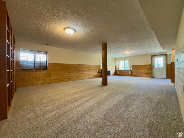485 S Woodland Hills Dr, Woodland Hills, UT 84653 - below grade area with wood walls, wainscoting, a textured ceiling, and carpet flooring