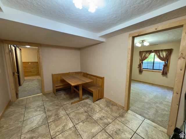 485 S Woodland Hills Dr, Woodland Hills, UT 84653 - unfurnished dining area with a textured ceiling, baseboards, and light colored carpet