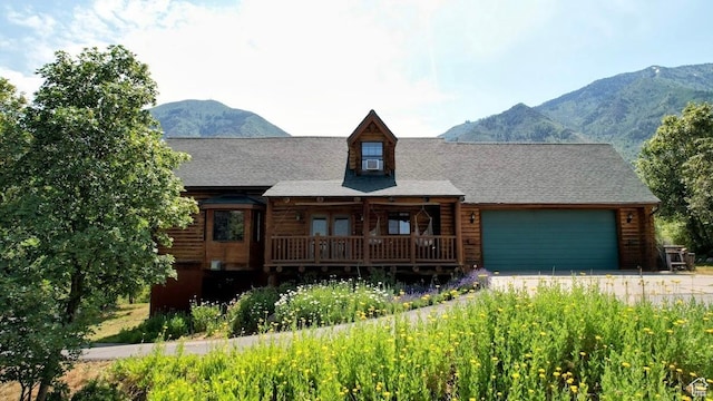 485 S Woodland Hills Dr, Woodland Hills, UT 84653 - log cabin with an attached garage, a mountain view, driveway, and cooling unit