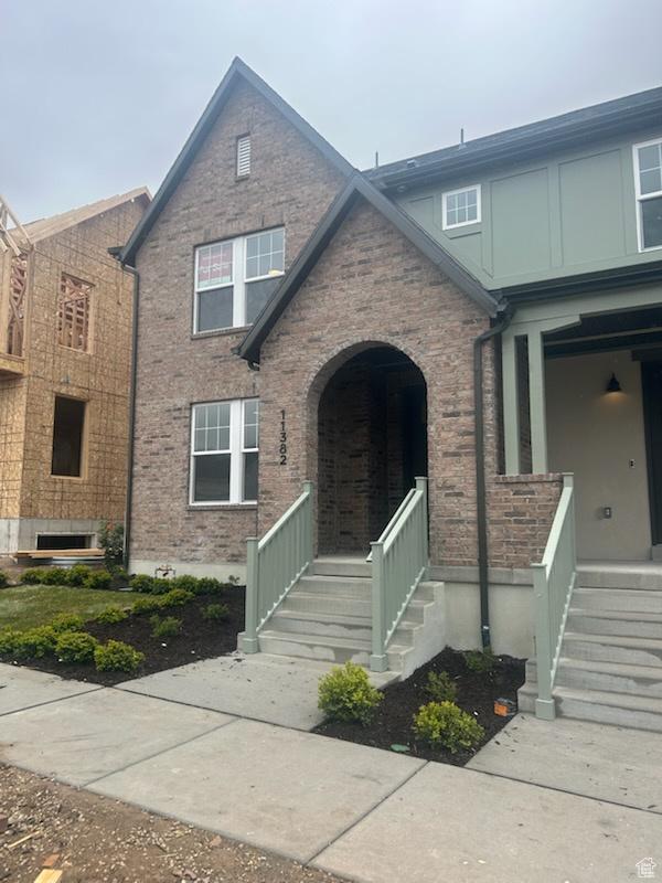 view of front of house featuring a porch and brick siding
