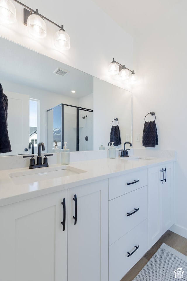 684 S 3550 W Unit 131, West Weber, UT 84401 - full bath with double vanity, a stall shower, and wood finished floors