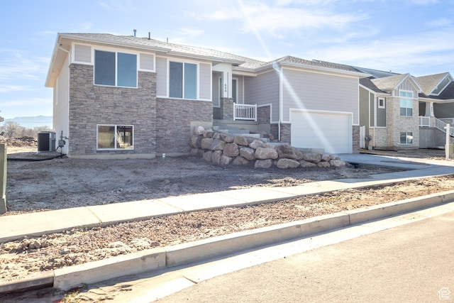 684 S 3550 W Unit 131, West Weber, UT 84401 - view of front of home featuring stone siding, cooling unit, and driveway