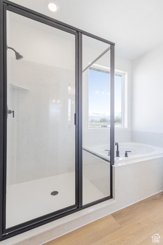 684 S 3550 W Unit 131, West Weber, UT 84401 - bathroom featuring a garden tub, wood finished floors, and a stall shower