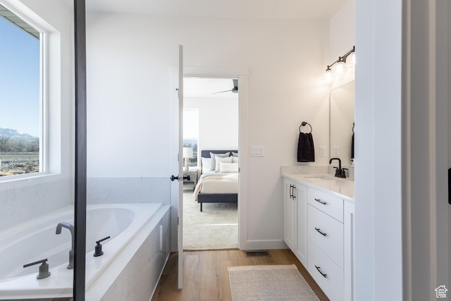 684 S 3550 W Unit 131, West Weber, UT 84401 - bathroom with vanity, ensuite bathroom, a garden tub, and wood finished floors