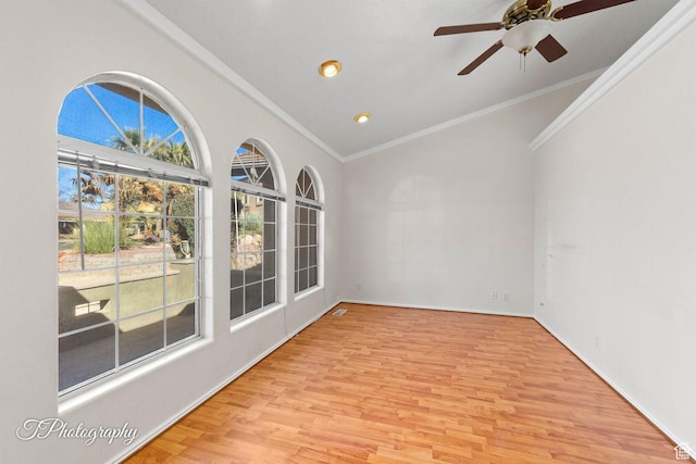 spare room featuring crown molding, ceiling fan, and light hardwood / wood-style floors