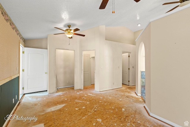 unfurnished bedroom with lofted ceiling and ceiling fan