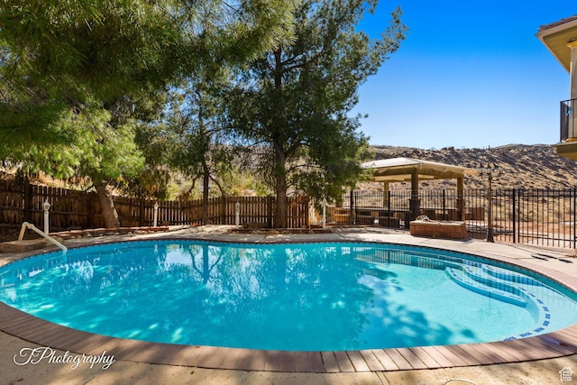 view of swimming pool with a mountain view