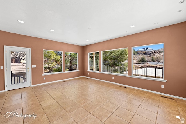 spare room featuring light tile patterned flooring