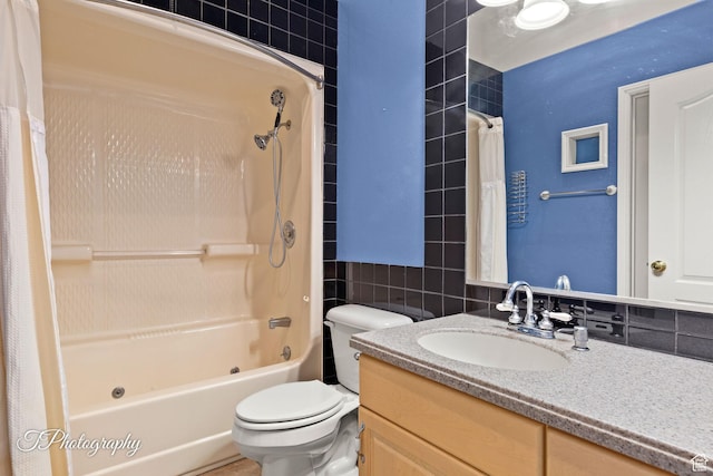 full bathroom with shower / tub combo with curtain, vanity, toilet, and tile walls