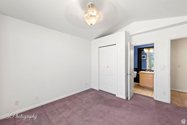 unfurnished bedroom with carpet flooring, a textured ceiling, and a closet