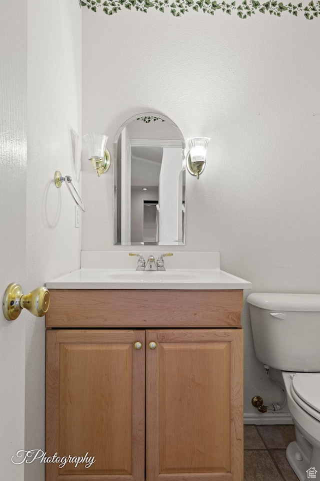 bathroom featuring tile patterned flooring, vanity, and toilet
