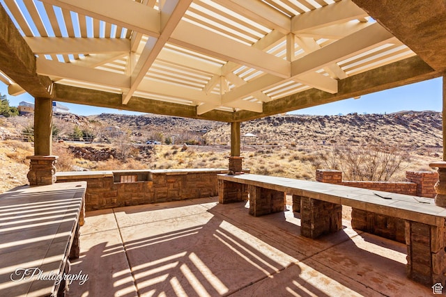 view of patio / terrace featuring a mountain view and a pergola