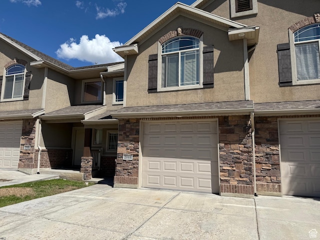 2044 N Evans Cove Loop W, Layton, UT 84041 - multi unit property with an attached garage, driveway, stone siding, and stucco siding