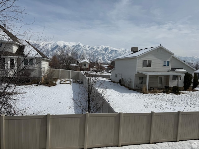 2044 N Evans Cove Loop W, Layton, UT 84041 - yard layered in snow featuring a fenced backyard and a mountain view
