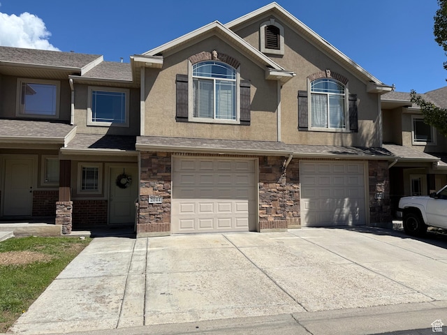 2044 N Evans Cove Loop W, Layton, UT 84041 - multi unit property with an attached garage, driveway, stucco siding, and stone siding