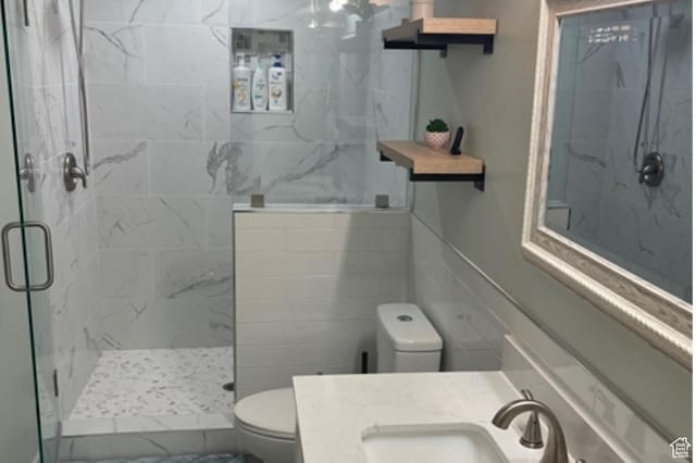 5171 W Dartford Way, West Valley City, UT 84120 - bathroom featuring a shower with door, vanity, and toilet